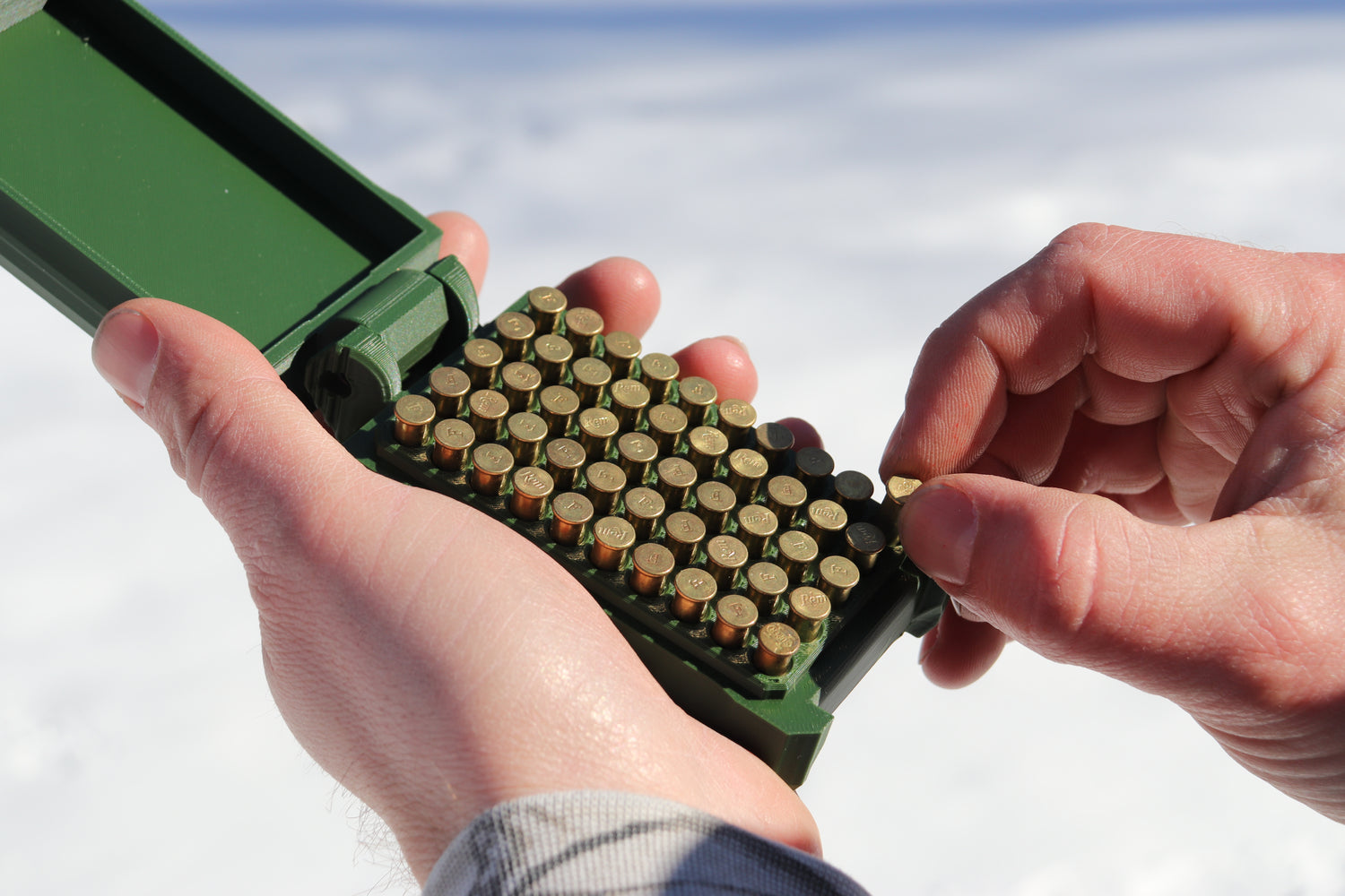 Pulling out a 22 LR round from an East Ridge Ammo Case